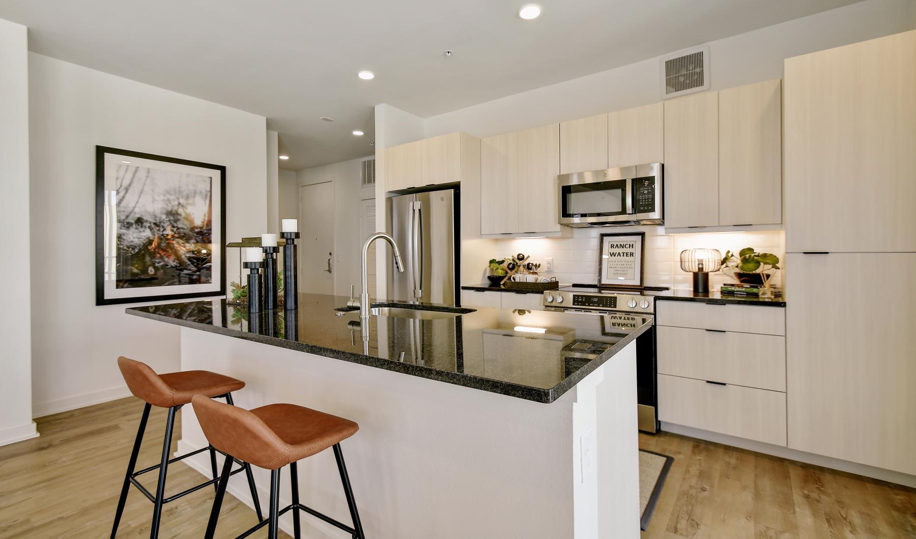 a kitchen with a bar stool and a table