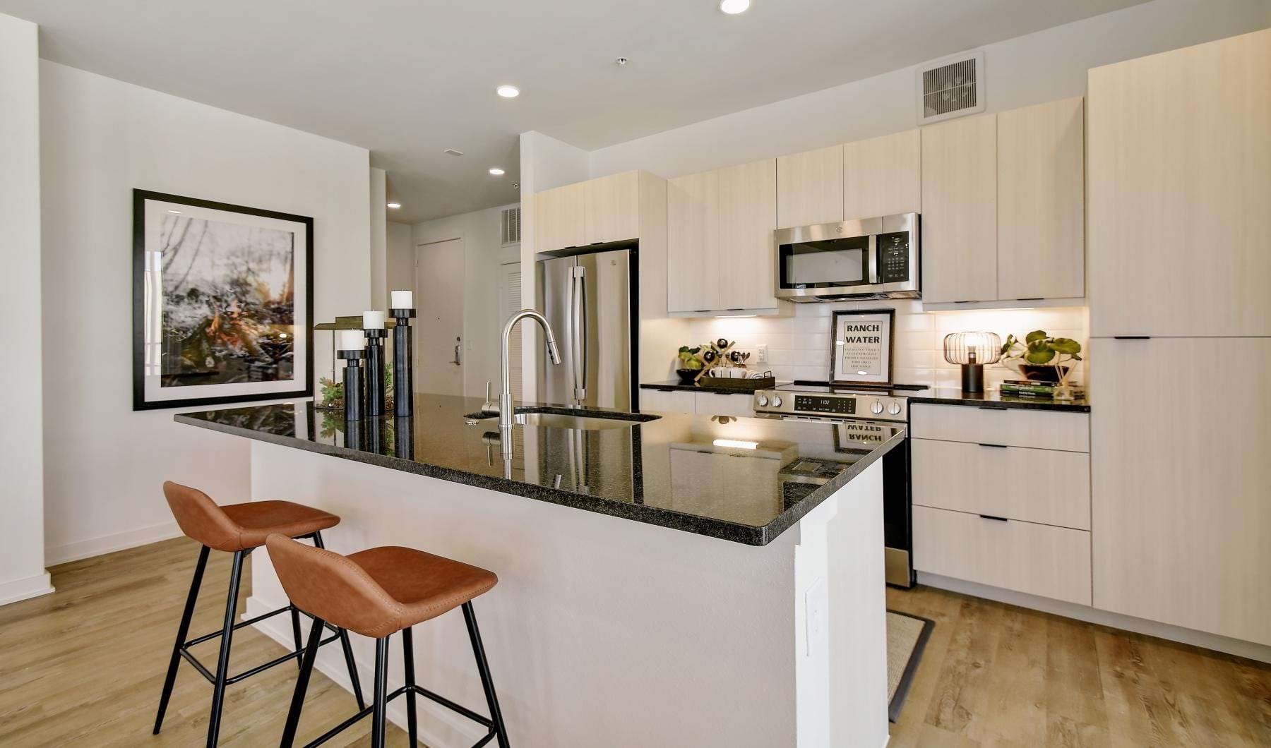 a kitchen with a bar stool and a table