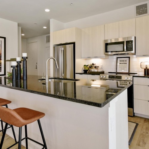 a kitchen with a bar stool and a table