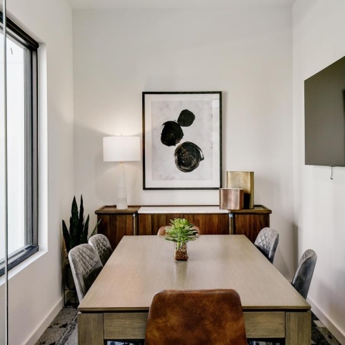 a spacious well-lit conference room with a large table