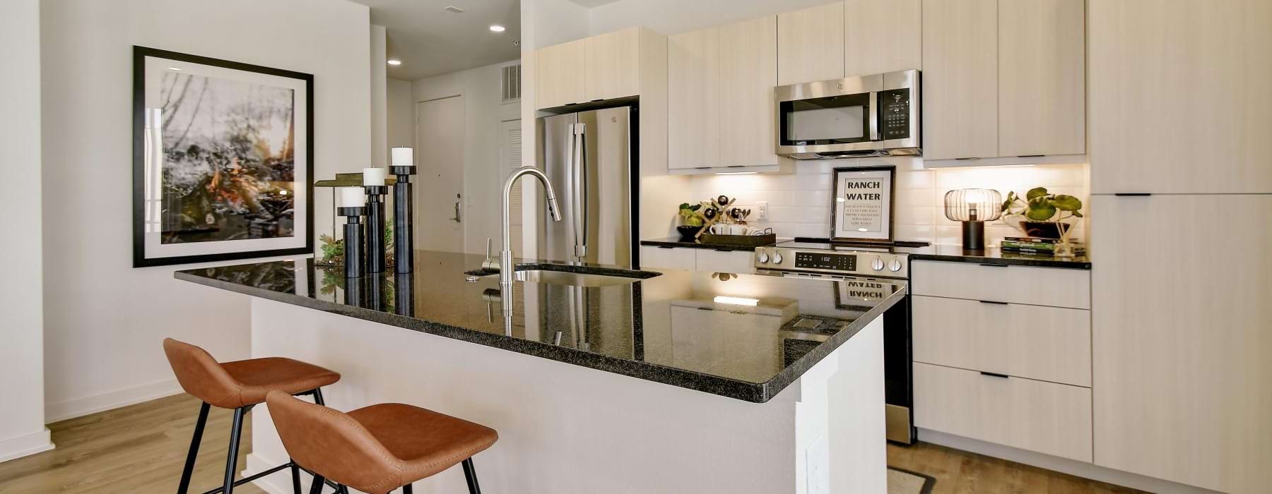 a kitchen with a bar stool and a table