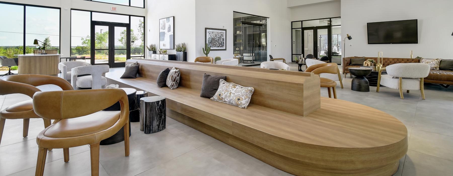 a large lounge area with wooden seating