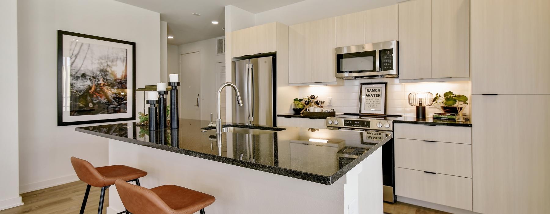 a kitchen with a bar stool and a table